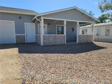View of front of house with a porch and garage