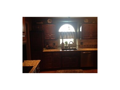 Kitchen boasts stainless steel appliances and gran