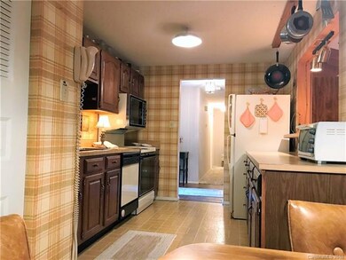 Kitchen view from breakfast area, laundry to left