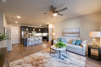 Living and kitchen -this is the furnished model, not actual unit, photo is for reference only