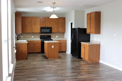 Kitchen featuring a kitchen island, backsplash, d