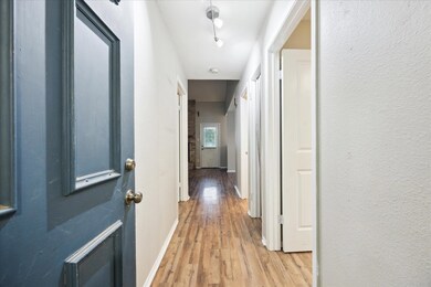 Hall featuring light wood-style flooring and base