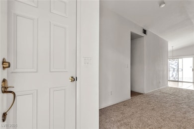 Spare room with carpet floors, baseboards, and a s