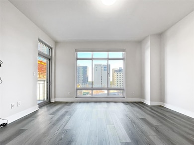 Empty room featuring dark wood finished floors, a