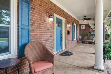 View of patio featuring ceiling fan and covered po