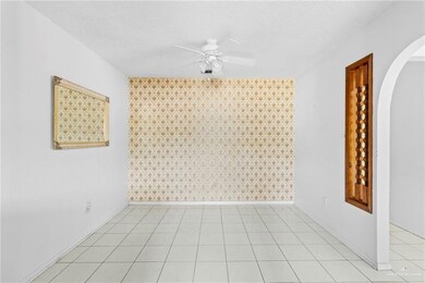 Spare room featuring ceiling fan and a textured ceiling
