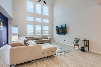 Living area with ceiling fan, wood finished floor