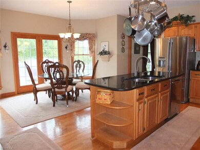 Kitchen has beautiful wood flooring and opens to t