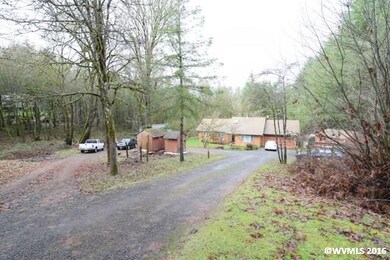 Driveway leads down to home away from road.
