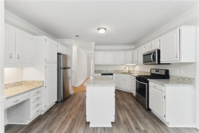 Kitchen with white cabinetry, a sink, ornamental m