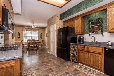 The kitchen has been updated with granite, gas sto