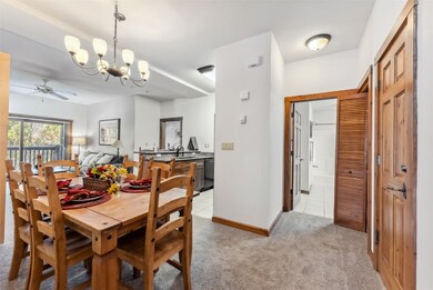 Dining room with baseboards, light carpet, and cei