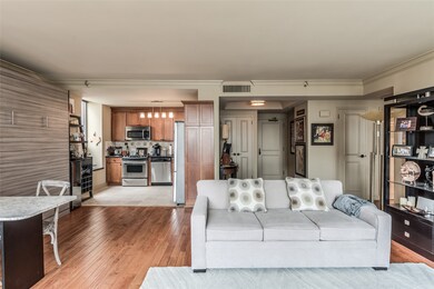View of the main public spaces of the unit - note the beautiful hardwood floors and crown molding details throughout the space.