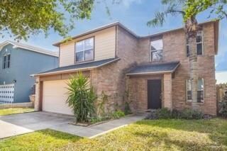 View of front property with a garage and a front yard