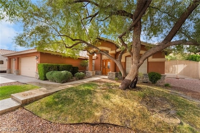 View of front of house with stucco siding, stone s