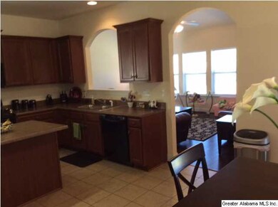 ANOTHER VIEW OF KITCHEN WITH ARCHED OPENING INTO T
