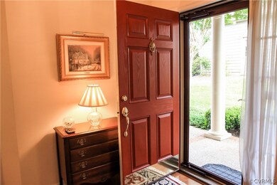 Welcoming red front door and clear glass storm doo