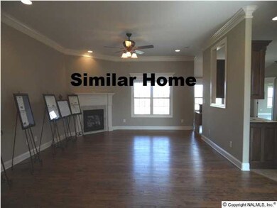 Family room with 10 foot ceilings, hardwood floor, ceiling fan, fireplace, recessed lights. Picture from similar home.