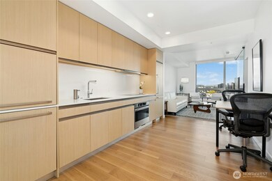 Sleek Kitchen with wood panel on appliances