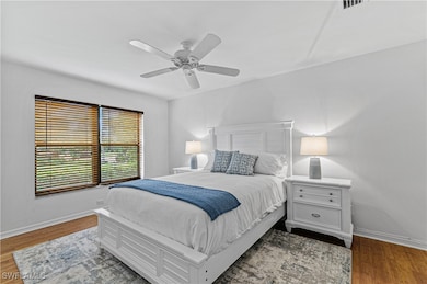Bedroom featuring ceiling fan and wood-type floori