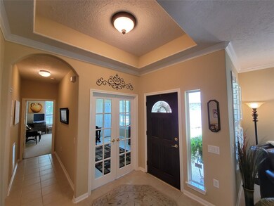 The foyer with tray ceiling is an elegant way to welcome your family and friends.  Note the French doors leading to the Study (or 3rd bedroom!).