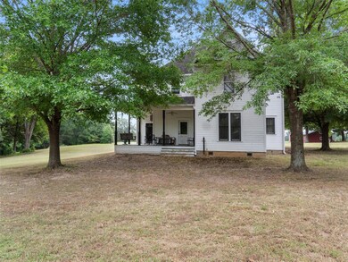 View of front of house with a front lawn, covered 