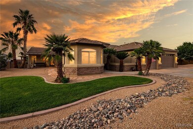 View of front of house featuring a garage and a ya