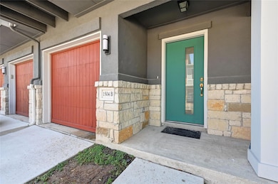 Property entrance featuring stucco siding