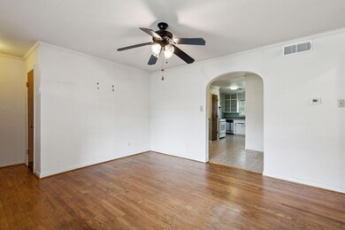 Tiled empty room featuring ceiling fan and ornamen