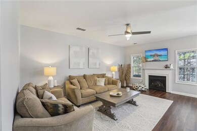 Living area featuring visible vents, dark wood fin