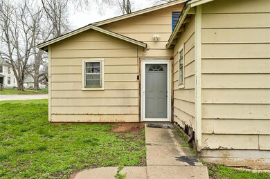 Doorway to property with a lawn