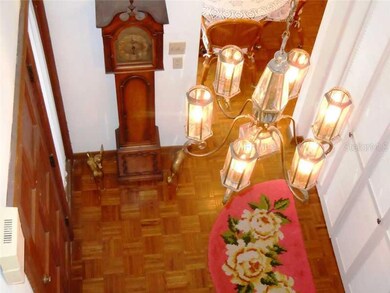 Foyer - Elegant 2 story foyer with closet storage and warm hardwood parquet floors.