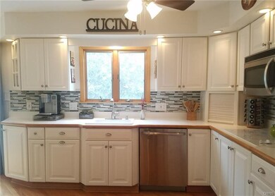 Beautiful remodeled kitchen has crisp white cabine