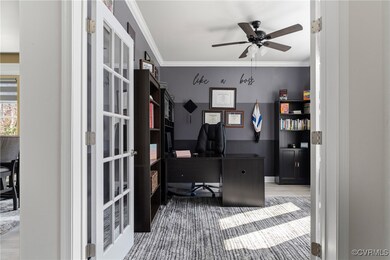 Office space featuring ceiling fan, light hardwood