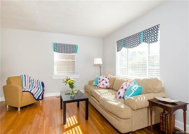 Two bright and sunny windows make the living room warm and inviting.