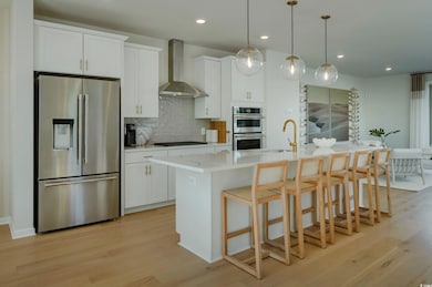 Kitchen featuring a center island with sink, white