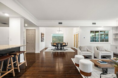 Living area featuring ornamental molding, visible