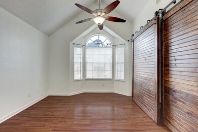 The front bedroom or office is filled with natural