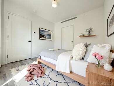 Bedroom with wood finished floors and baseboards