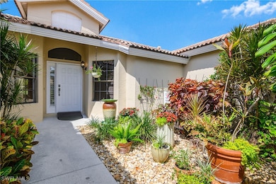 Property entrance featuring stucco siding and a ti