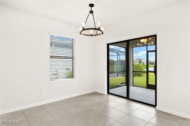DINING AREA featuring a chandelier, plenty of natural light, and light tile patterned flooring