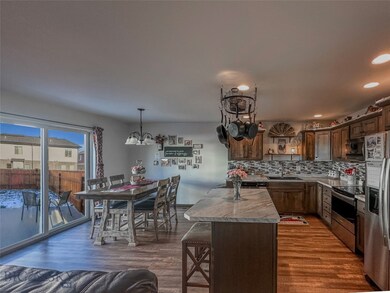 Kitchen featuring dark wood-type flooring, stainle