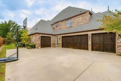 Exterior drive with a 4 car garage and basketball goal.  The perfect place to shoot hoops