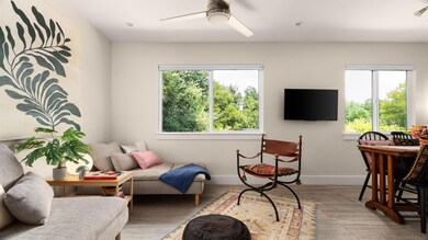 Living area with healthy amount of natural light, ceiling fan, and wood finished floors