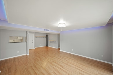 The kitchen, dining area, and living room flow tog