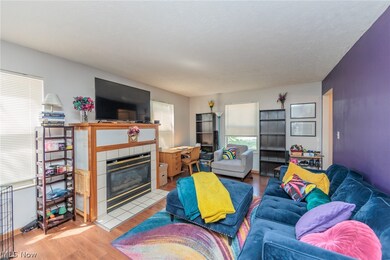 laminate / wood-style floors and a tiled fireplace