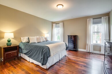 Inviting master suite with beautiful hardwoods and lots of natural light with tall ceilings. 