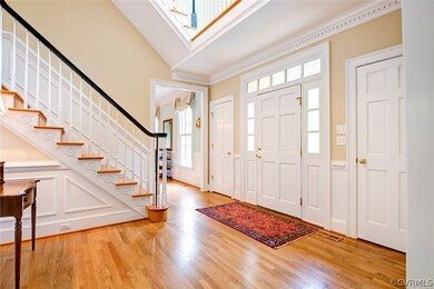 Two story foyer with double coat closet
