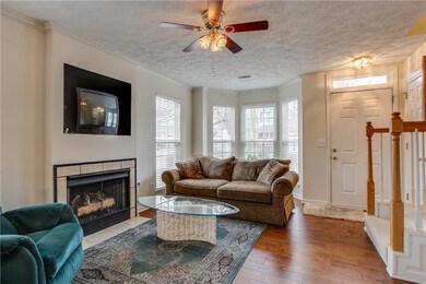Living room fireplace has gas logs. It works great! This big bay window brings in lots of natural light. Coat closet by door.