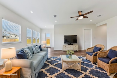 Living room with recessed lighting, visible vents